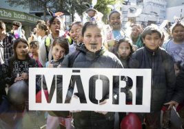 Matariki is a Māori tradition. Māori is on a sign held up proudly by a group of children.